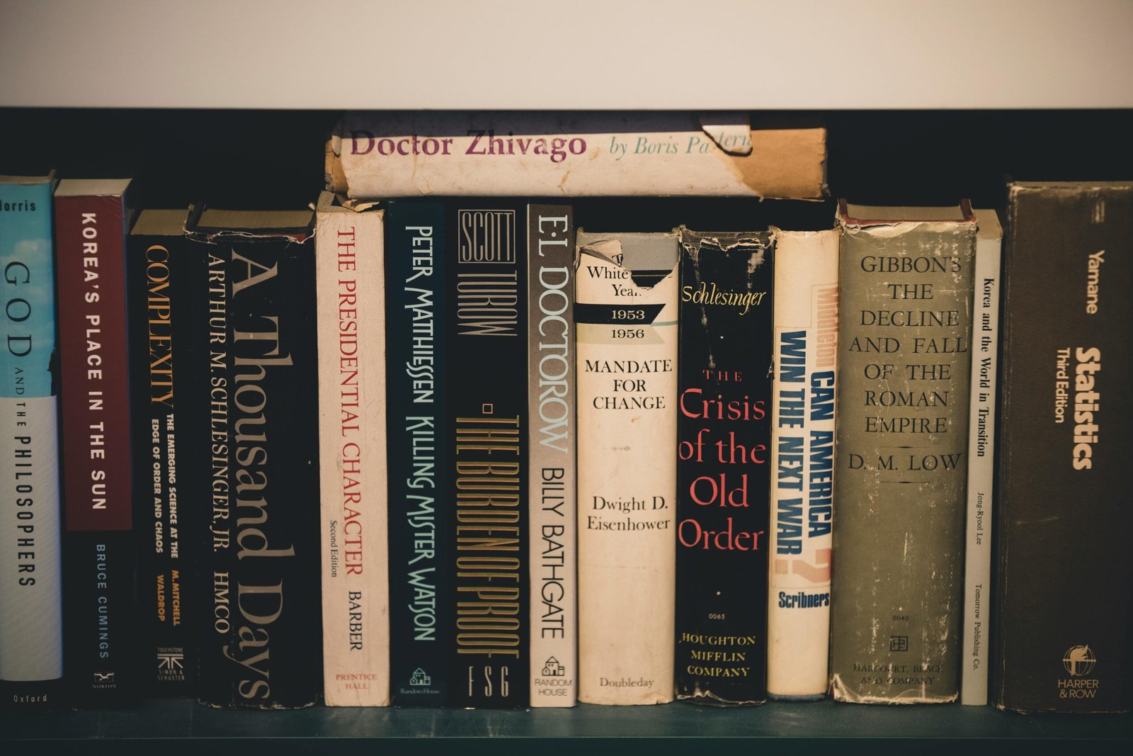 Home Close-up of classic literature on a wooden bookshelf, providing a vintage and educational feel.